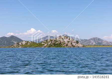 Scenic view of Lake Skadar with green rocky islands under a clear blue sky 143516281