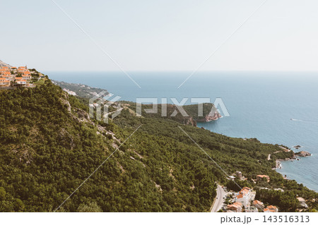 Scenic hillside village overlooking Adriatic Sea coastline in Sveti Stefan Scenic hillside village overlooking Adriatic Sea coastline in Sveti Stefan 143516313