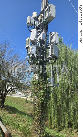 Cellular telecommunication tower antenna against blue sky Cellular telecommunication tower antenna against blue sky 143518008