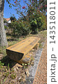 Old wooden boat covered with tarp on green grass yard 143518011