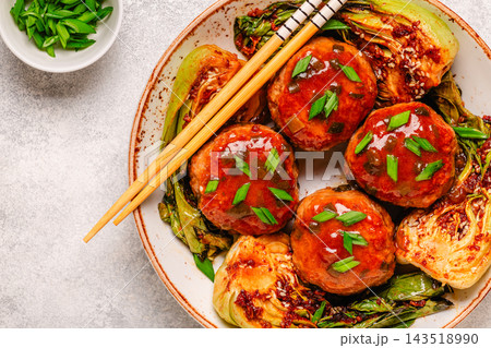 Delicious meatballs served with cooked cabbage bok choy. 143518990