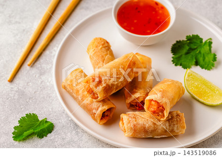 Fried spring rolls served with lime and sauce Fried spring rolls served with lime and sauce 143519086
