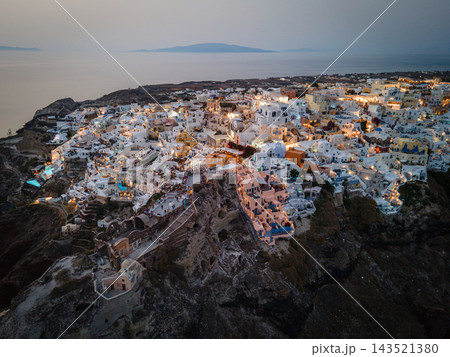 Aerial Drone View of Oia, Santorini. A breathtaking aerial view of the whitewashed village of Oia, Santorini, showcasing luxury resorts with infinity pools overlooking the Aegean Sea. A stunning blend Aerial Drone View of Oia, Santorini. A breathtaking aerial view of the whitewashed village of Oia, Santorini, showcasing luxury resorts with infinity pools overlooking the Aegean Sea. A stunning blend 143521380