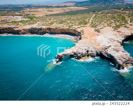 Sunny Beach with Waves in Rethymno, Crete. A beautiful wild beach in Rethymno, Crete, Greece, just before the main port. Gentle waves roll onto the untouched shoreline under the warm sun, creating a p Sunny Beach with Waves in Rethymno, Crete. A beautiful wild beach in Rethymno, Crete, Greece, just before the main port. Gentle waves roll onto the untouched shoreline under the warm sun, creating a p 143522224