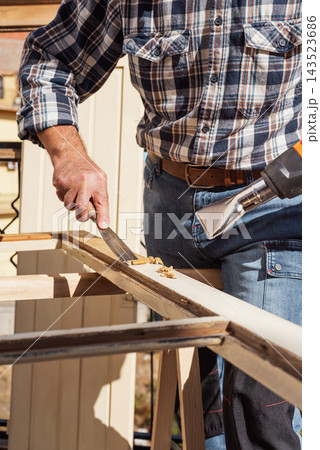 Carpenter at work, restoring an old wooden window. Carpentry. 143523686