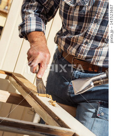 Carpenter at work, restoring an old wooden window. Carpentry. 143523687