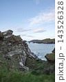 Rugged coastal landscape overlooking the Atlantic Ocean near Baltimore in West Cork Ireland during a calm afternoon with rocky cliffs and green hills. 143526328