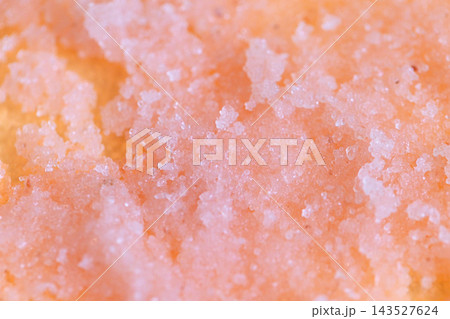 Abstract macro texture of coarse translucent orange and pale pink crystalline granules with uneven granular surface and softly blended color variations, mineral inspired background Abstract macro texture of coarse translucent orange and pale pink crystalline granules with uneven granular surface and softly blended color variations, mineral inspired background 143527624