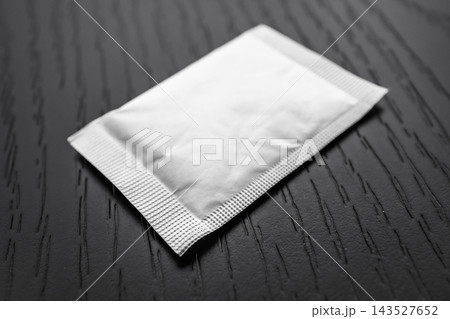 selective focus of blank white sachet mockup packet on wooden surface selective focus of blank white sachet mockup packet on wooden surface 143527652