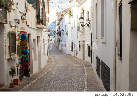 Exploring Altea's charming old town with its picturesque winding cobblestone streets, an ideal setting for memorable Spanish family holidays and vacations Exploring Altea's charming old town with its picturesque winding cobblestone streets, an ideal setting for memorable Spanish family holidays and vacations 143528398