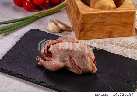 Fresh Raw Quail Game Bird with Garlic, Green Onions, Tomatoes 143529184