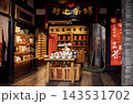 Traditional tea shop interior with wooden shelves displaying tea products, a wooden table in the center, and decorative banners in a culturally rich setting 143531702