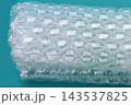 Clear plastic bubble wrap on green plate close up 143537825