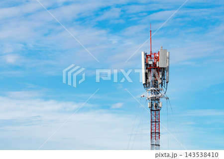 Telecommunication tower with cellular antennas against blue sky, wireless communication infrastructure for mobile network coverage, data transmission and modern digital connectivity. 143538410
