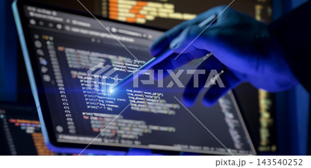 Cybersecurity expert or digital forensics investigator in dark gloves pointing at malicious software script with a stylus. Cybersecurity expert or digital forensics investigator in dark gloves pointing at malicious software script with a stylus. 143540252