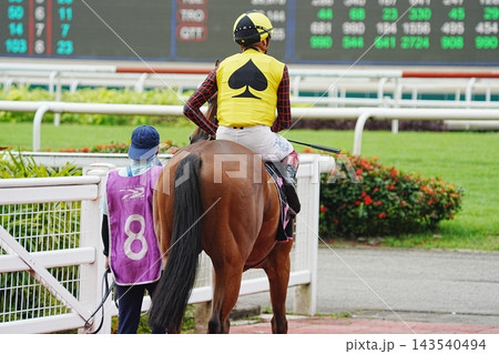 Horse Racing Jockey at the Track Waiting for Next Race 143540494
