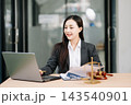 Beautiful asian woman lawyer working and gavel, tablet, laptop in front, Advice justice 143540901