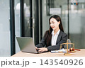 Beautiful asian woman lawyer working and gavel, tablet, laptop in front, Advice justice 143540926