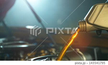 Mechanical Pouring Fresh New Motor Oil into Car's Engine 143541795