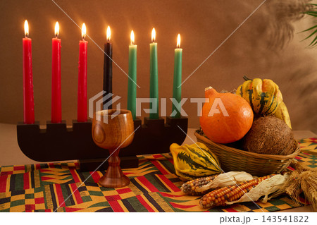 Kwanzaa kinara with mishumaa saba and traditional harvest symbols Kwanzaa kinara with mishumaa saba and traditional harvest symbols 143541822