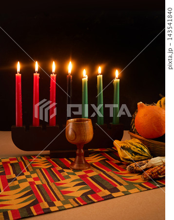 Kwanzaa celebration with kinara, mishumaa saba, and unity cup 143541840