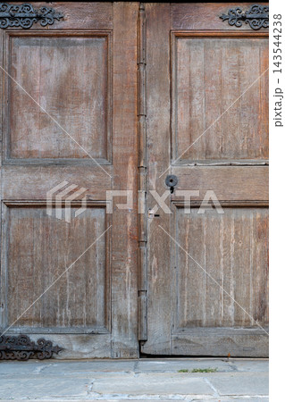 Rustic Wooden Double Door With Weathered Panels, Metal Hinges and Stone Threshold in Vintage Style Rustic Wooden Double Door With Weathered Panels, Metal Hinges and Stone Threshold in Vintage Style 143544238