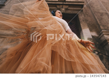 Woman Dancing with Headphones in Historic City 143547143