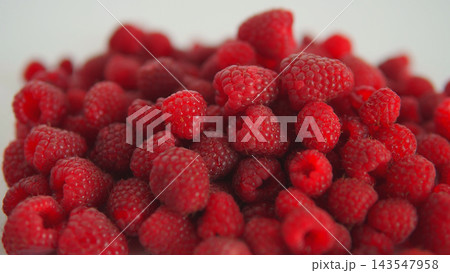 Raspberries filling the frame, creating a heap of fresh, ripe, and sweet organic fruit ready for healthy eating Raspberries filling the frame, creating a heap of fresh, ripe, and sweet organic fruit ready for healthy eating 143547958