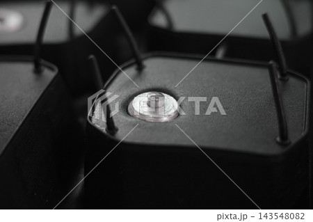 Studded winter tire tread closeup with metal spike detail. 143548082