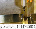 Surface finishing process of mold parts using a long ball nose end mill and oil coolant on a CNC milling machine 143548953