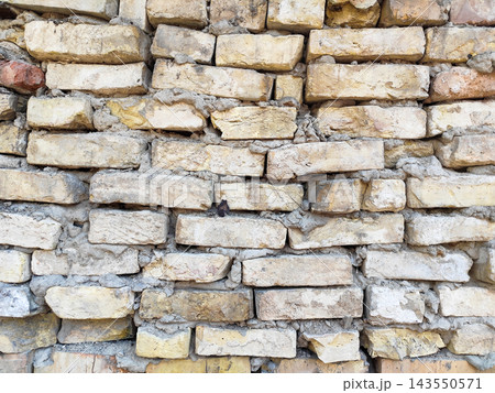 Texture of Weathered Antique Brick Wall with Sloping Rows and Gray Mortar Background 143550571