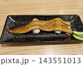 Grilled Anago Sushi, Long Conger Eel Nigiri with Sweet Tare Sauce and Sesame on Black Plate, Japanese Food 143551013
