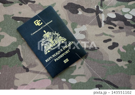 Haitian passport on table close up. Official identification document book for citizens of Haiti. Concept of travel and tourism in Haiti Haitian passport on table close up. Official identification document book for citizens of Haiti. Concept of travel and tourism in Haiti 143551102