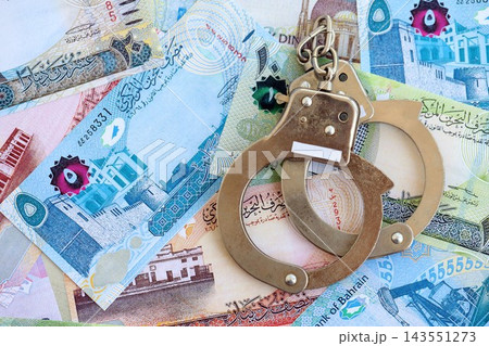 Bahraini dinar currency money bills and handcuffs. The concept of criminal Bahraini dinar currency money bills and handcuffs. The concept of criminal 143551273