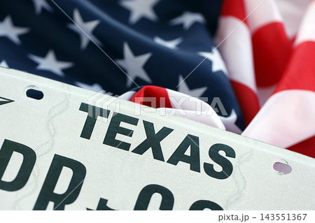 USA state of Texas license plate on US flag. Car driving in Texas 143551367