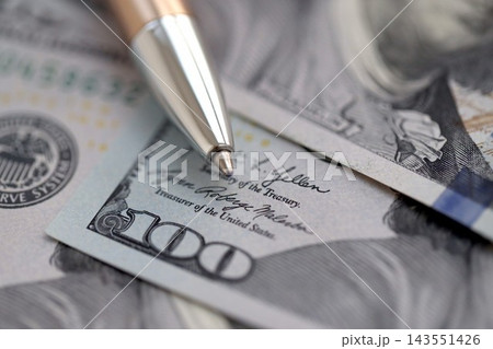 One hundred US dollar bills and silver pen close up. Concept of business calculating and accounting One hundred US dollar bills and silver pen close up. Concept of business calculating and accounting 143551426