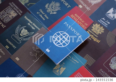 Fictional passport book travel document on big amount of real passport covers 143551536