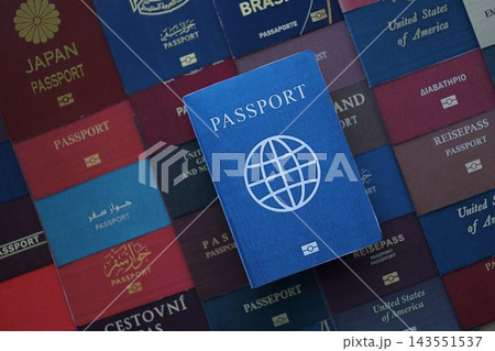 Fictional passport book travel document on big amount of real passport covers Fictional passport book travel document on big amount of real passport covers 143551537