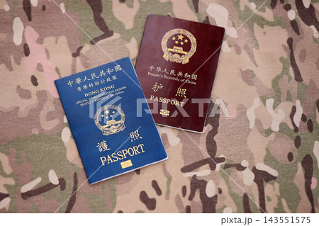 Chinese and Hong Kong passport on table. Official identification document book for citizens 143551575