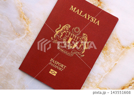 Malaysian passport on table. Official identification document book for citizens of Malaysia Malaysian passport on table. Official identification document book for citizens of Malaysia 143551608