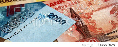 Ugandan shilling paper banknotes pile on table. Uganda UGX currency money bills in big amount Ugandan shilling paper banknotes pile on table. Uganda UGX currency money bills in big amount 143551629