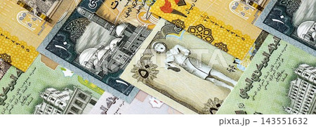 Yemeni rial paper banknotes pile on table. Yemen YER currency money bills in big amount Yemeni rial paper banknotes pile on table. Yemen YER currency money bills in big amount 143551632
