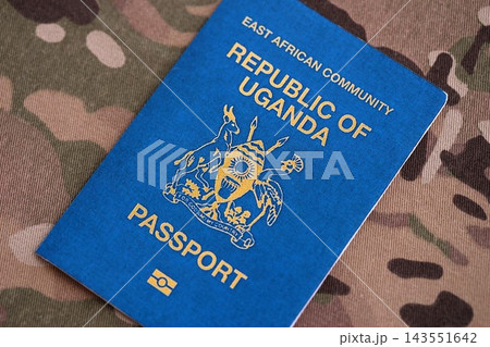 Ugandan passport on table close up. Official identification document book for citizens of Uganda Ugandan passport on table close up. Official identification document book for citizens of Uganda 143551642