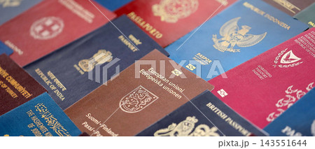 Big amount of passports of various different countries. Covers of expired passports close up Big amount of passports of various different countries. Covers of expired passports close up 143551644