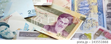 Iranian rial money bills pile on table. Iran banknotes of IRR currency close up. Concept of business Iranian rial money bills pile on table. Iran banknotes of IRR currency close up. Concept of business 143551668