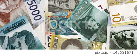 Serbian dinar money bills pile on table. Serbia banknotes of RSD currency. Concept of business Serbian dinar money bills pile on table. Serbia banknotes of RSD currency. Concept of business 143551671