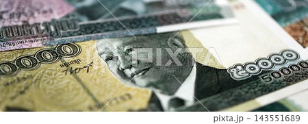 Cambodian riel money bills pile on table. Cambodia banknotes of KHR currency close up 143551689