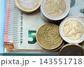 Eurozone euro money bills and cent coins pile on table. Eurozone coins on banknotes of EUR currency 143551718