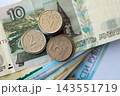 Russian ruble money bills and kopek coins pile on table. Russian coins on banknotes of RUB currency 143551719