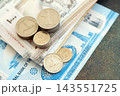 UAE dirham money bills and fils coins pile. United Arab Emirates coins on banknotes of AED currency 143551725